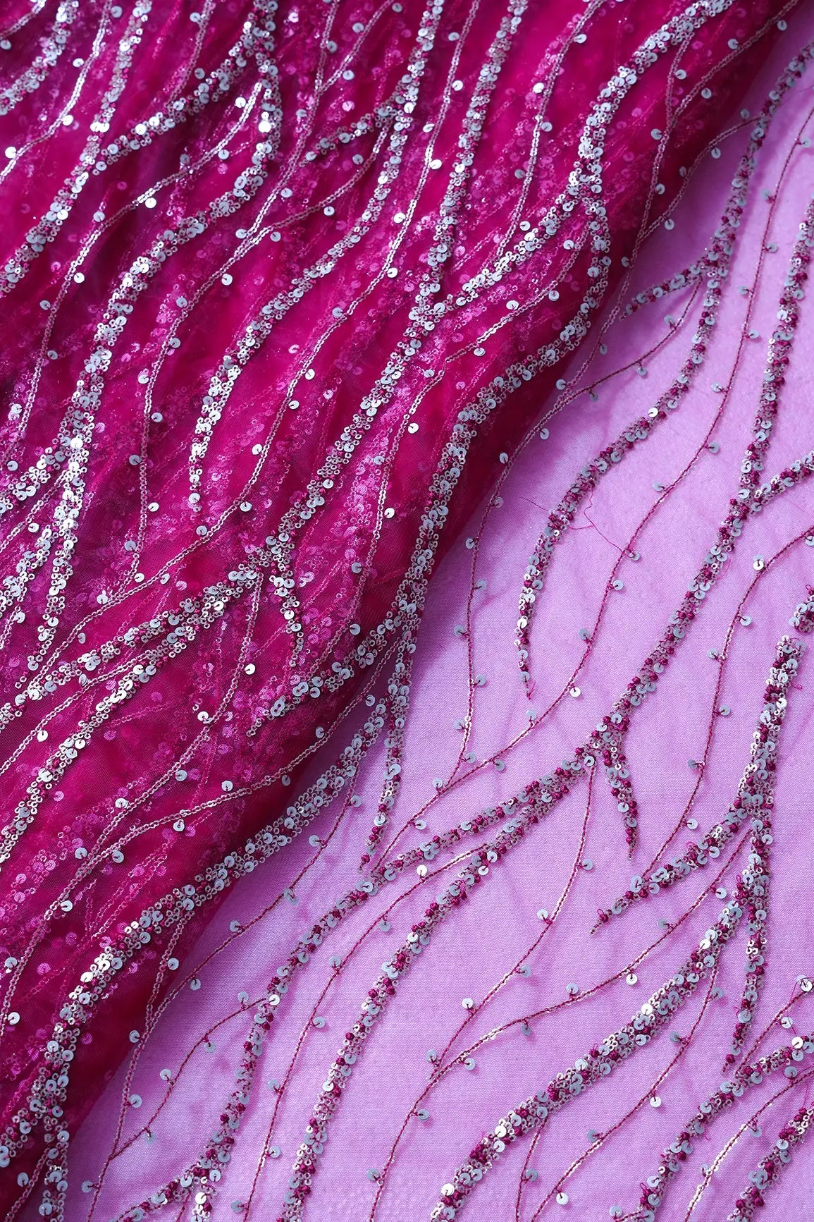 Gold And Silver Sequins With Fuchsia Thread Wavy Embroidery Work On Fuchsia Soft Net Fabric - doeraa